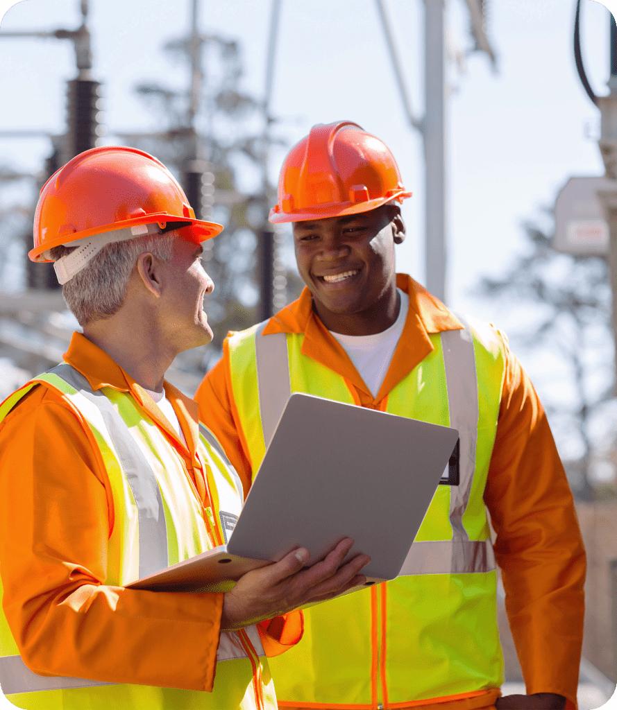 Electrical workers with laptop smiling