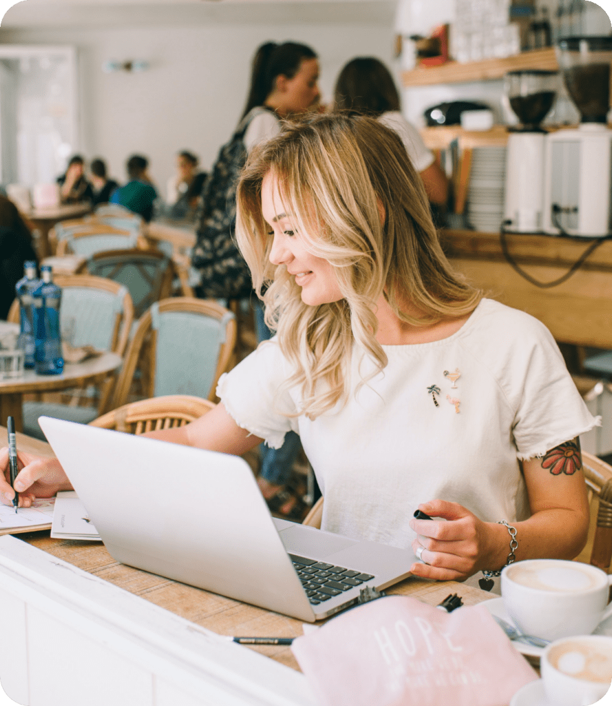 Small business owner with open laptop at coffee shop