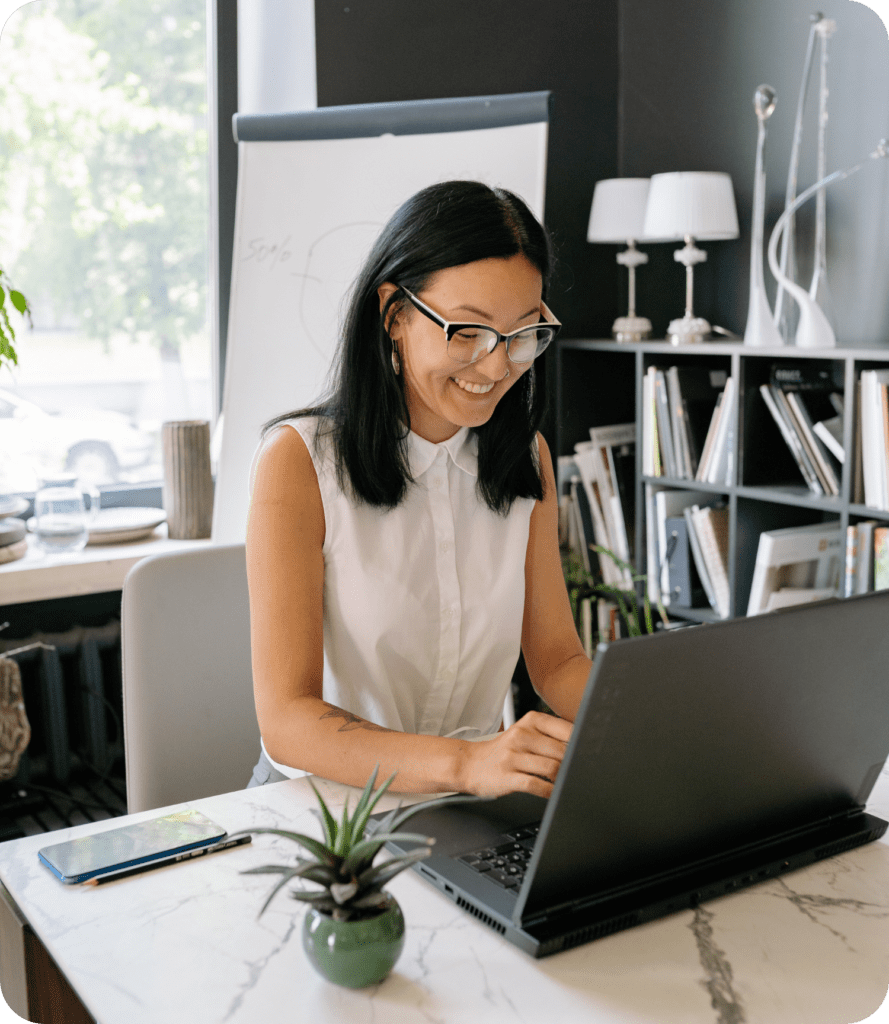 Office worker smiling at computer