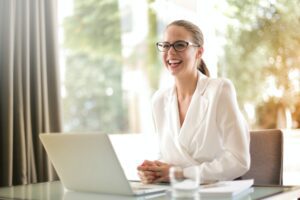 Business woman laughing with computer
