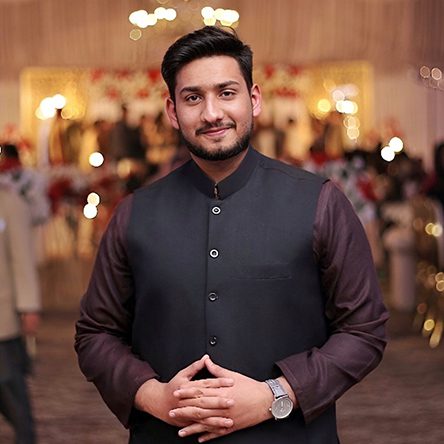 Headshot of Muhammad Osama Iftikhar, formal attire with a blurred background at an event.