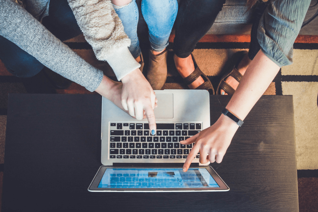 Hands pointing at computer